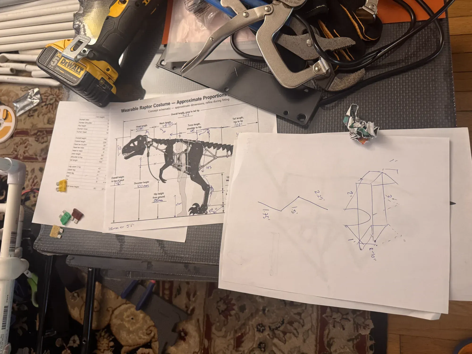 A printed Raptor plan beside a hand-drawn frame cross-section, drill, clamps, aluminum plates, and PVC