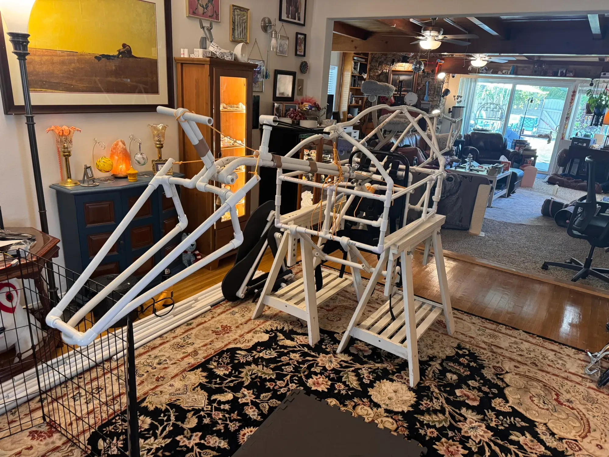 The frame up on sawhorses in profile, nose to tail across the room
