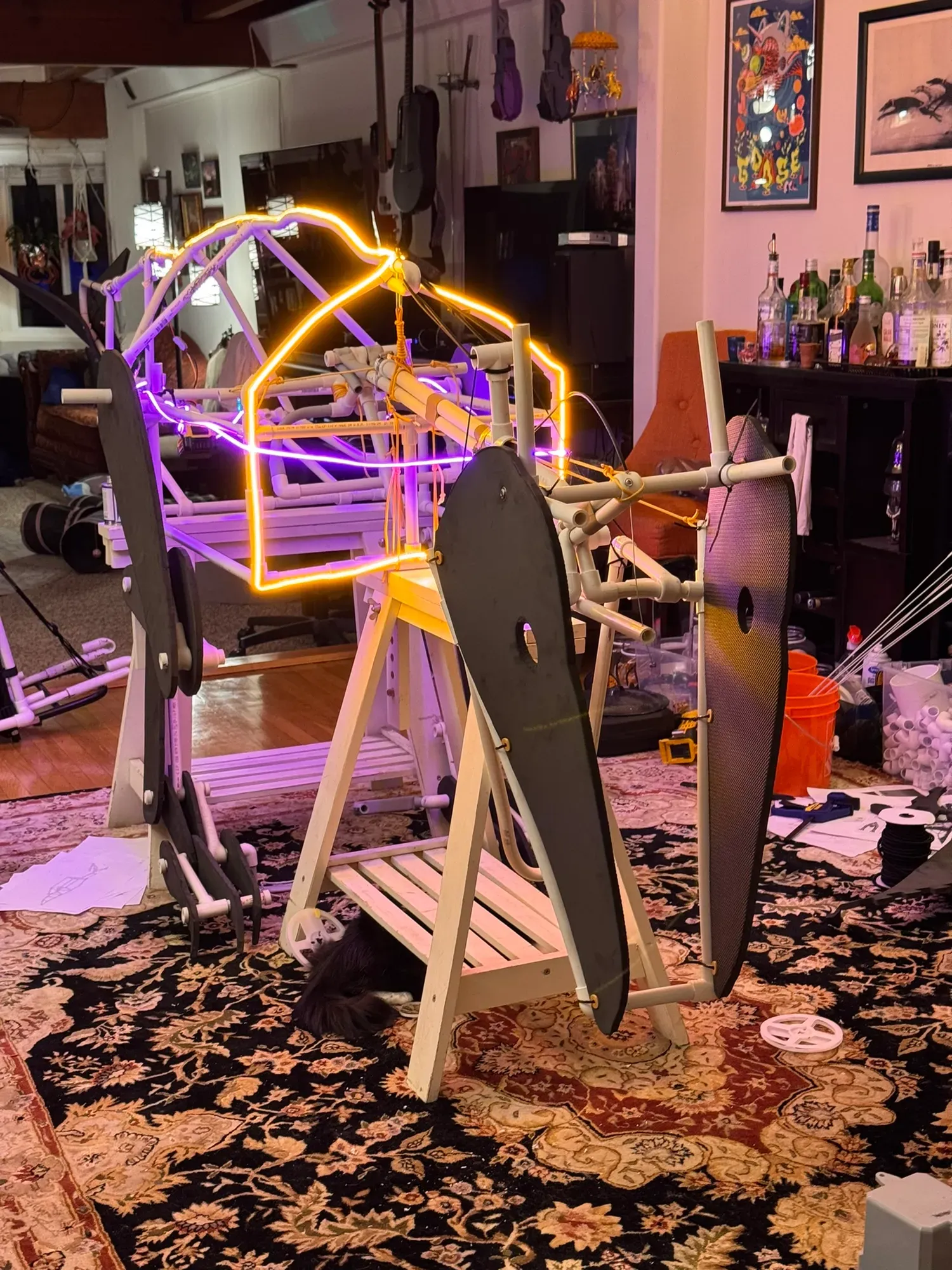 The light test from behind: glowing outline over the tail truss with foam tail plates in silhouette